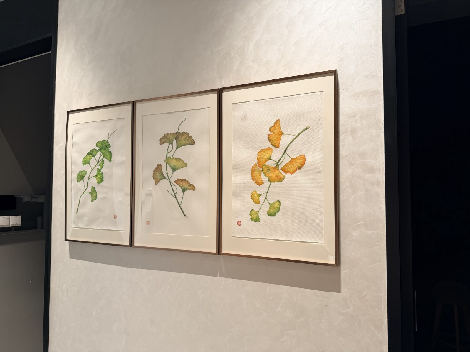 A triptych of ginkgo leaf paintings hanging in the Calm Dental clinic at Millenia Walk